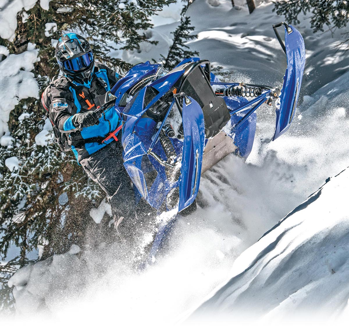 a rider on a blue snowmobile