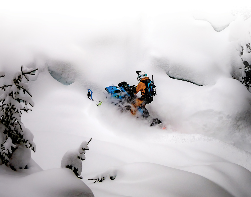 snowmobile rider going uphill