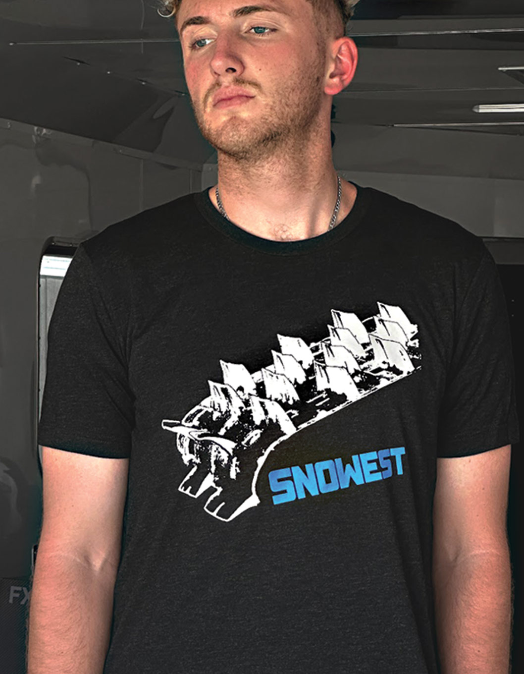 man wearing a SnoWest shirt