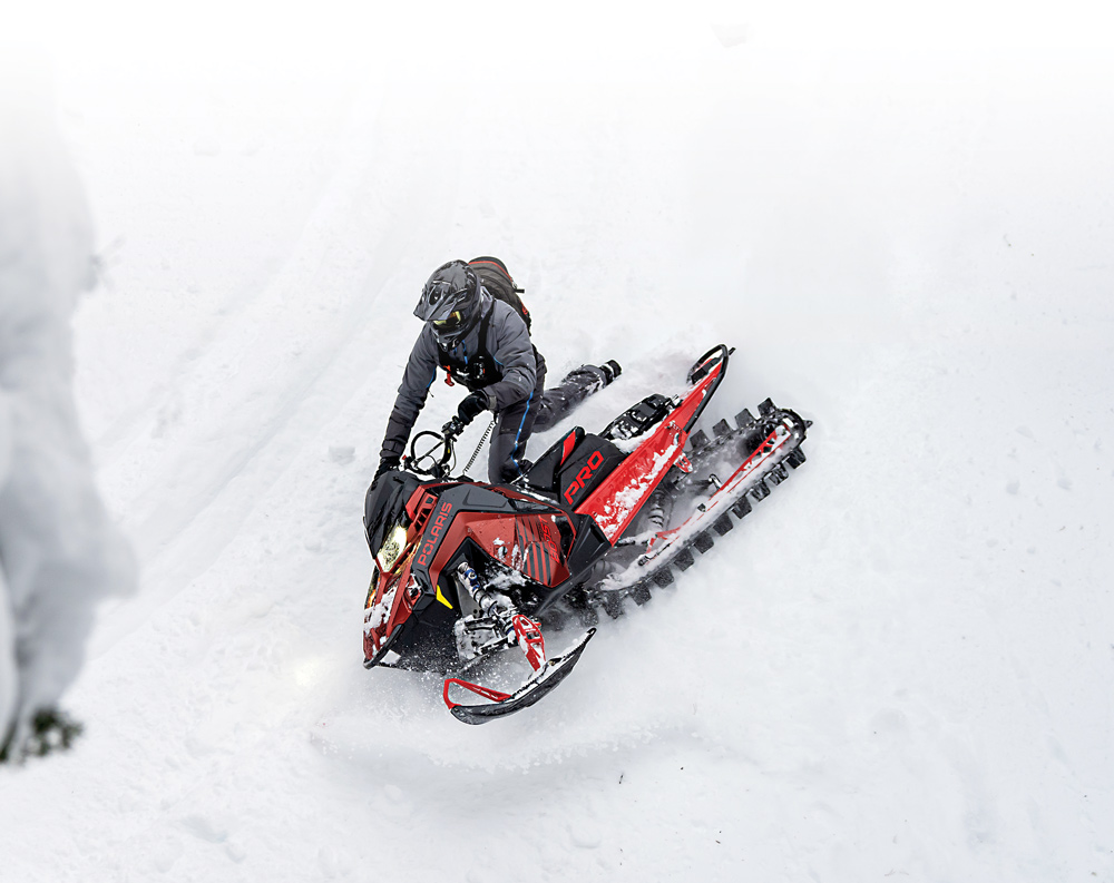snowmobile rider going downhill