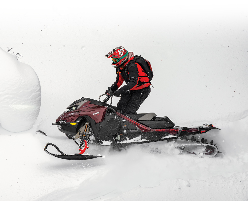 rider wearing red on a LYNX snowmobile